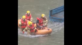 Firefighters use dinghy to rescue resident from Macau floods