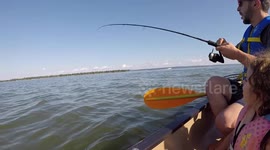 Dad catches huge pike with huge lamprey stuck to it