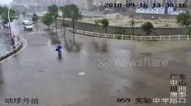 Cyclist stranded in powerful wind caused by Typhoon Mangkhut