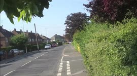 Car driving down middle of road