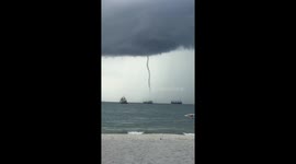 Aussie tourist's hilarious reaction to 'tornado' heading towards packed beach