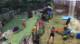 Neighbours from 'Heaven' enjoy a huge water fight during glorious summer's day