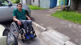 Disabled man tests out wheelchair ramp and falls backwards