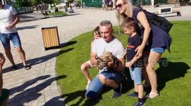 Tourists pose for pictures with frightened tiger cub in Ukranian zoo