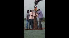 Crane snaps during religious ceremony dropping four men 20 feet into water