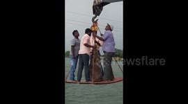 Snapped crane drops four men 20 feet into water during religious ceremony