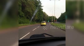 Driver is caught on camera watching the Champions League final on his phone while at the wheel after swerving across the road