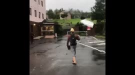 Man struggles with umbrella in Japan during Typhoon Jebi
