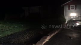 Flood waters pick up car