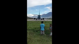 Cheeky boys knocked over by wind from jet plane