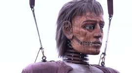 Gigantic puppets preform throughout Liverpool