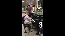 Musical commuters in London’s kings cross take the stage on the public piano performing a lovely duet to fellow commuters
