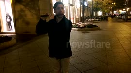 Fife player on the streets of Boston at night.