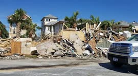 Piles of debris from flattened houses lie on side of Mexico Beach roads