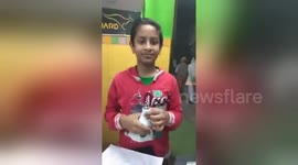 The incredible moment an Indian boy lights up a light bulb with just his bare hands