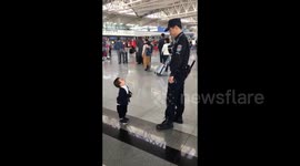 Cute boy just wants a hug from airport security guard