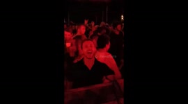 Reveller makes rooster noises at beach party