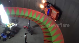 Pick-up truck takes on motorcycle wall of death at Thai fair