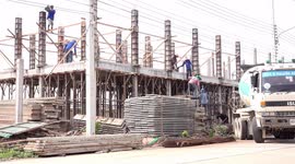 Team work on a building site in Asia.