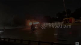 Drivers flee their vehicles on the motorway after an abandoned car rolls past -- on FIRE