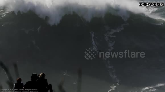 Surfer rides Gigantic Wave and suffers a Massive Wipeout at Nazaré, Portugal during the first XXL size swell of the Season