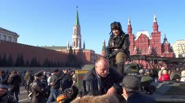 Man on a tank is showing fig sign to a selfie girl in Red Square