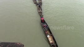'Burkis' or small boats ferry the stones to locations from where trucks take them to the crushing plant.