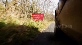 Several potholes on a country road in Cumbria.