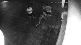 The woman was snatched the phone by a robber when she was playing the game in front of the restaurant