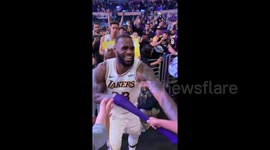 Young fan freaks out when LeBron hands his arm sleeve to him