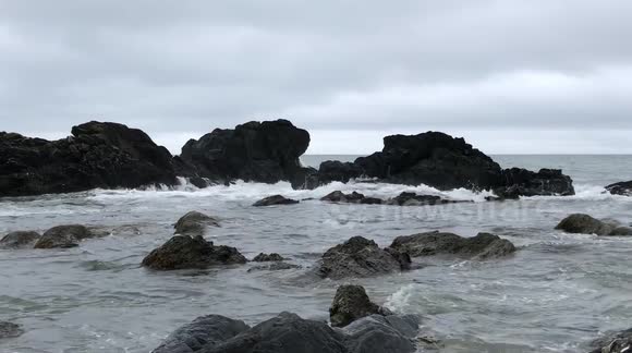 Waves washing over Rocks on a Beach