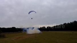 Paraglider's close call with a barrel full of explosives