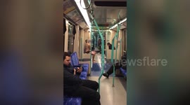 Half-naked man oils himself up then pole-dances on the London Tube
