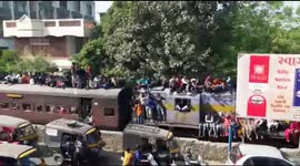 Indian pilgrims surf train in huge numbers en route to holy festival