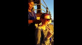 Mayan woman making a hairstyle for European girl. Guatemala.