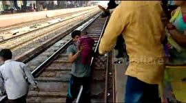 LONGER VERSION: Moment miracle baby emerges unscathed after falling onto tracks and under moving train