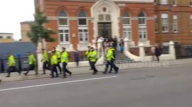 FILE: Police fall back as protesters hurl bottles and rocks during protest in Dalston