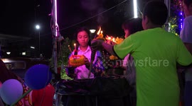 Thai people lighting their floats before putting on water, during the Loikratong festival.