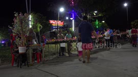 Thai people celebrate Loikratong festival, by paying respect to the water, and dancing in the street.
