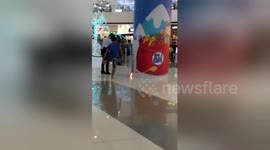 Shopper calmly puts out electrical fire by throwing his FLIP-FLOPS at flames