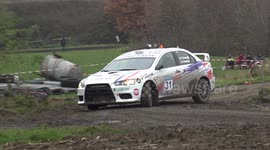 Rally drivers swerve and lose control turning difficult corner