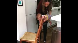Baby dragging a chair