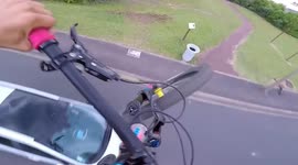 Daredevil cyclist uses car to boost speed in spectacular jumps