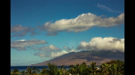 Clouds moving over turbines on the West Maui Mountains