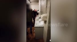 Police hunt football hooligans filmed smashing up toilets during riot