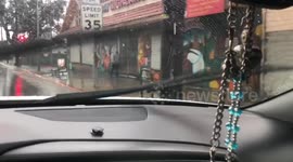 Heavy Rain run down floods business driveway Los Angeles uneven roads and potholes make it hard for residents to navigate through