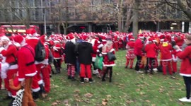 Santas descend on Euston Square ahead of SantaCon parade