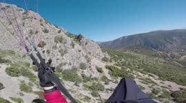 Hawk attacking paraglider
