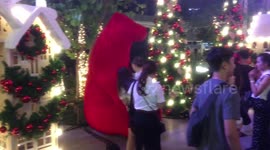 Christmas characters mix with shoppers.