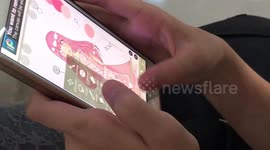 Child using a coloring ap. On a mobile phone.